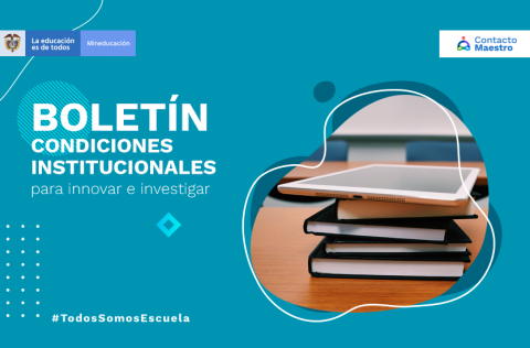 unos libros y una tableta en la mesa de un salón de clases